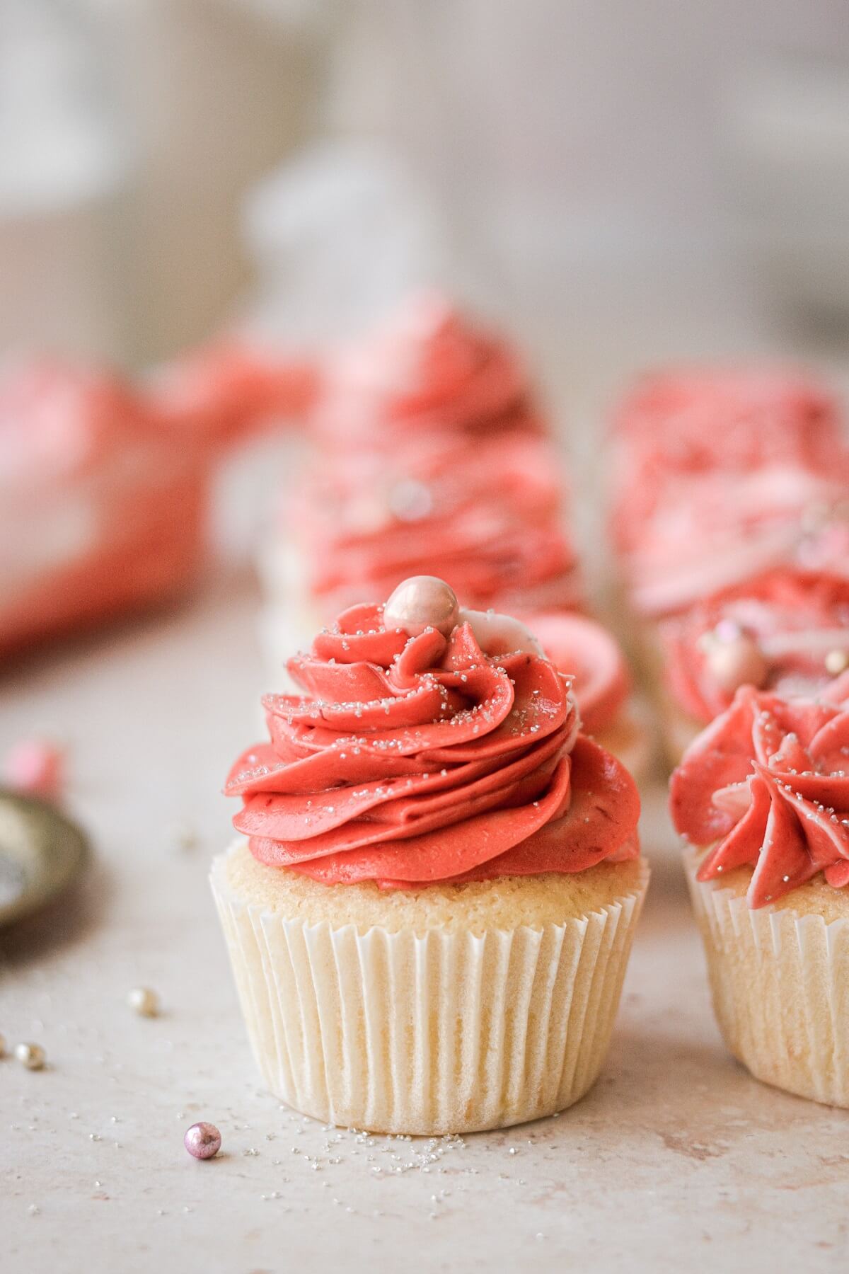 A cupcake with a classic swirl of pink frosting.