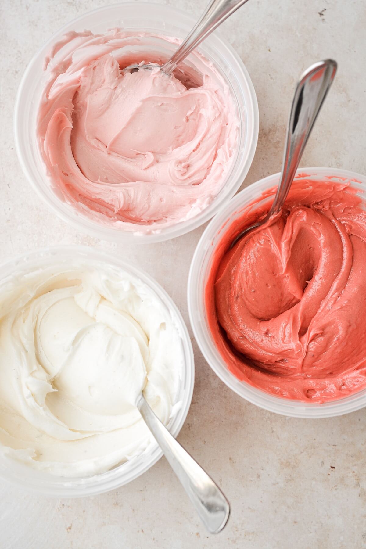 Bowls of pink and white buttercream.