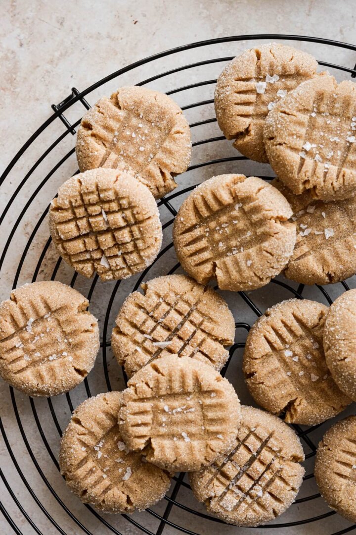 3 ingredient peanut butter cookies on a black cooling rack.
