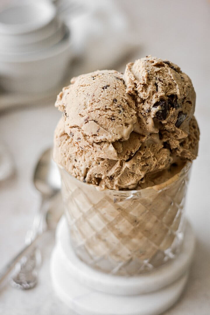 Scoops of peanut butter mocha chocolate chip no churn ice cream in a glass.