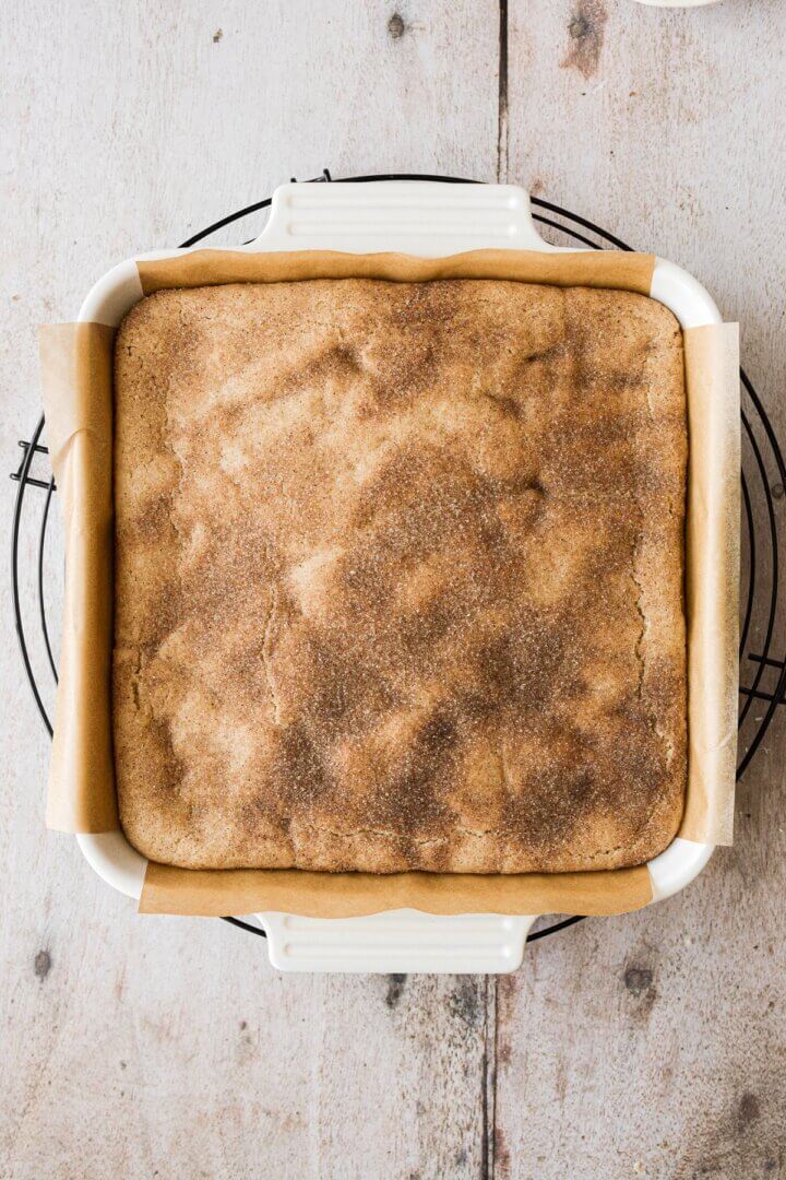 Snickerdoodle cheesecake crust in a baking pan.