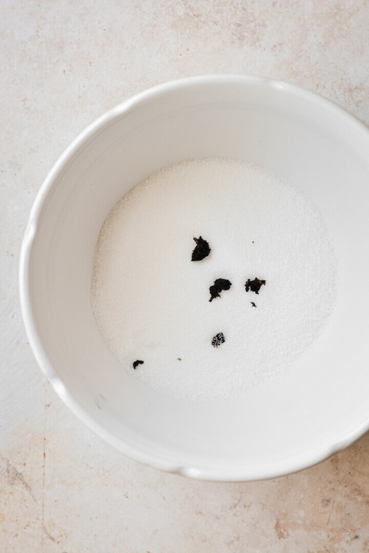 Bowl of sugar with vanilla bean seeds.