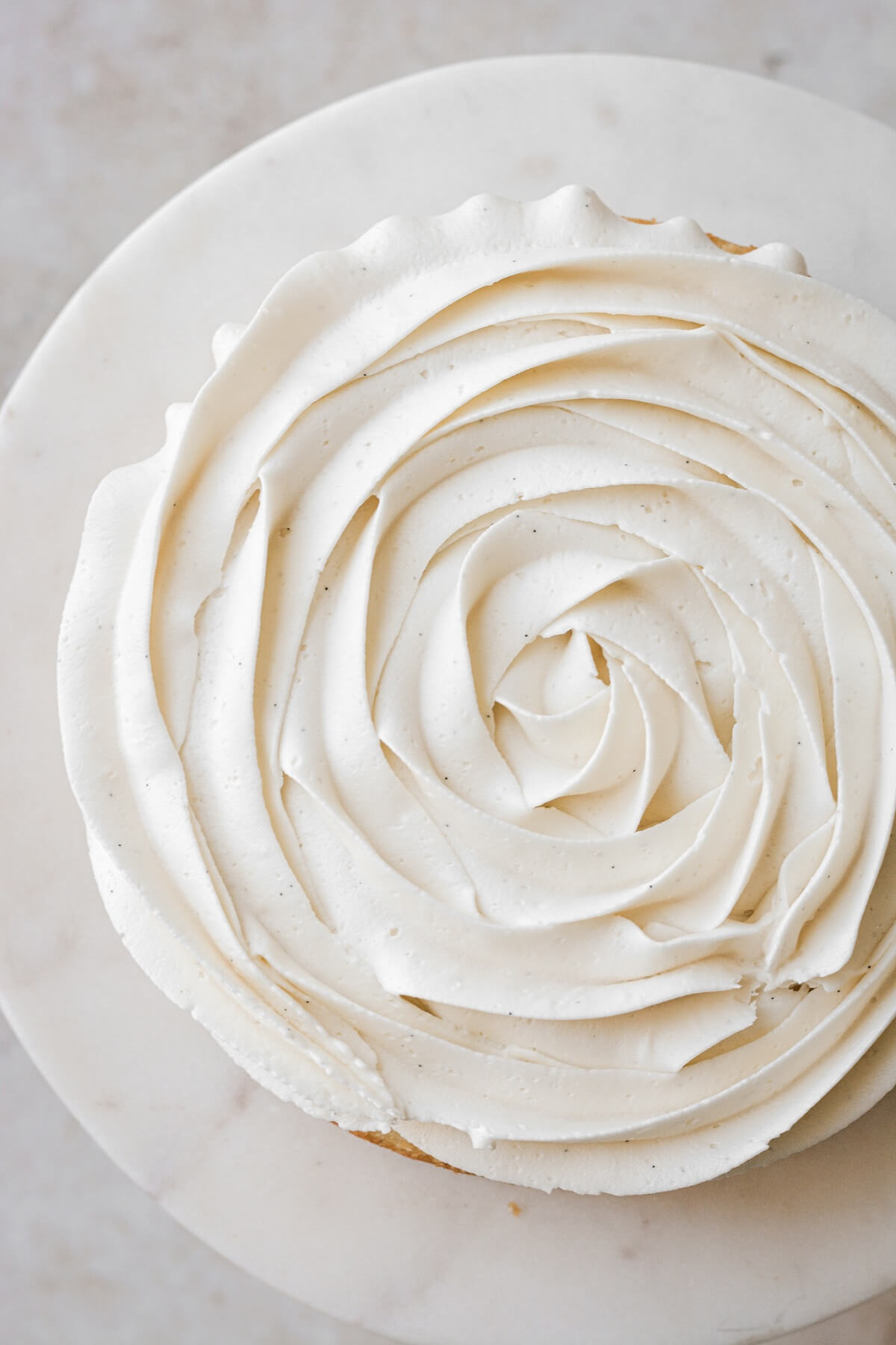 Vanilla buttercream piped in a large rosette on top of a cake.