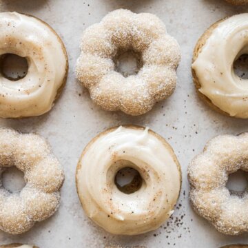 Baked maple donuts coated in sugar and topped with maple icing.