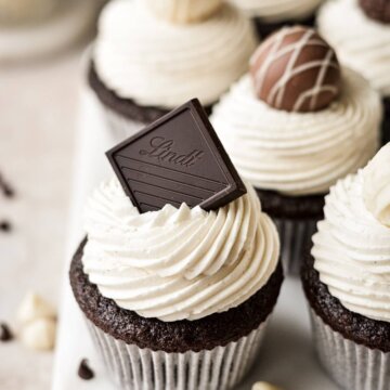 Lindt chocolate square on a black and white chocolate cupcake.