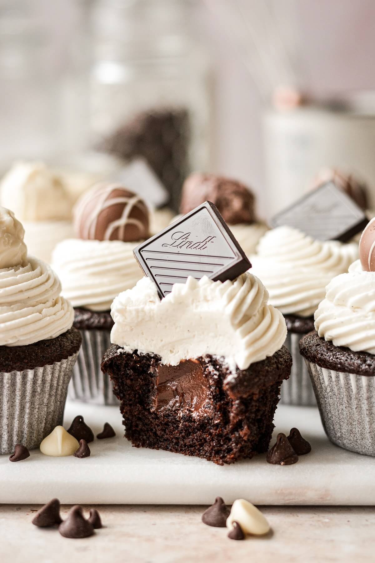 Black and white chocolate cupcakes, one with a bite taken.