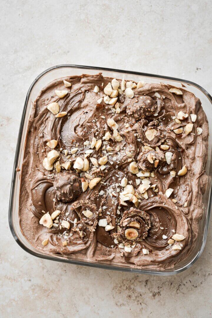 Chocolate hazelnut ice cream with hazelnuts and Nutella swirl.