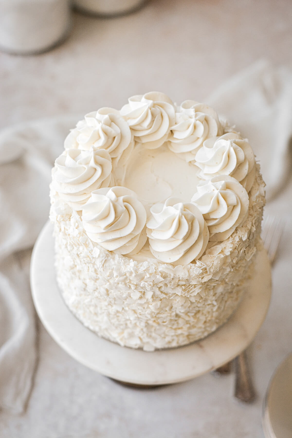 Top view of buttercream swirls on a coconut cake.