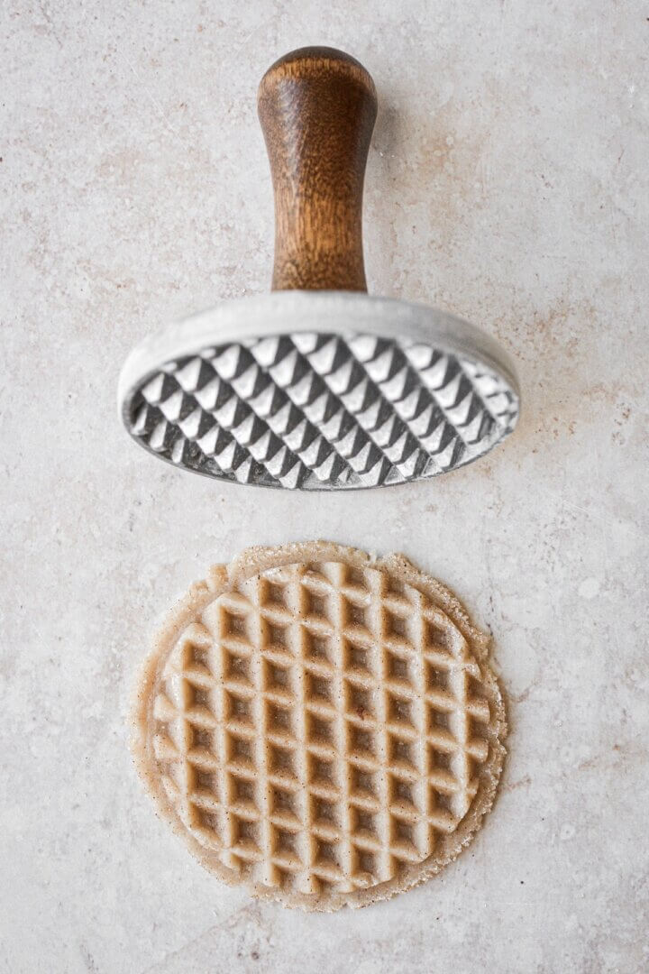 Step 2 for pressing snickerdoodle dough with waffle stamp.