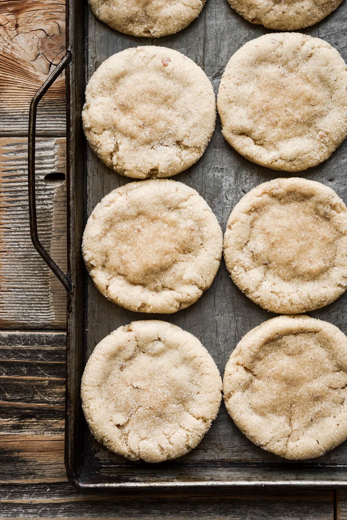 Brown sugar pecan cookies on a metal baking sheet.