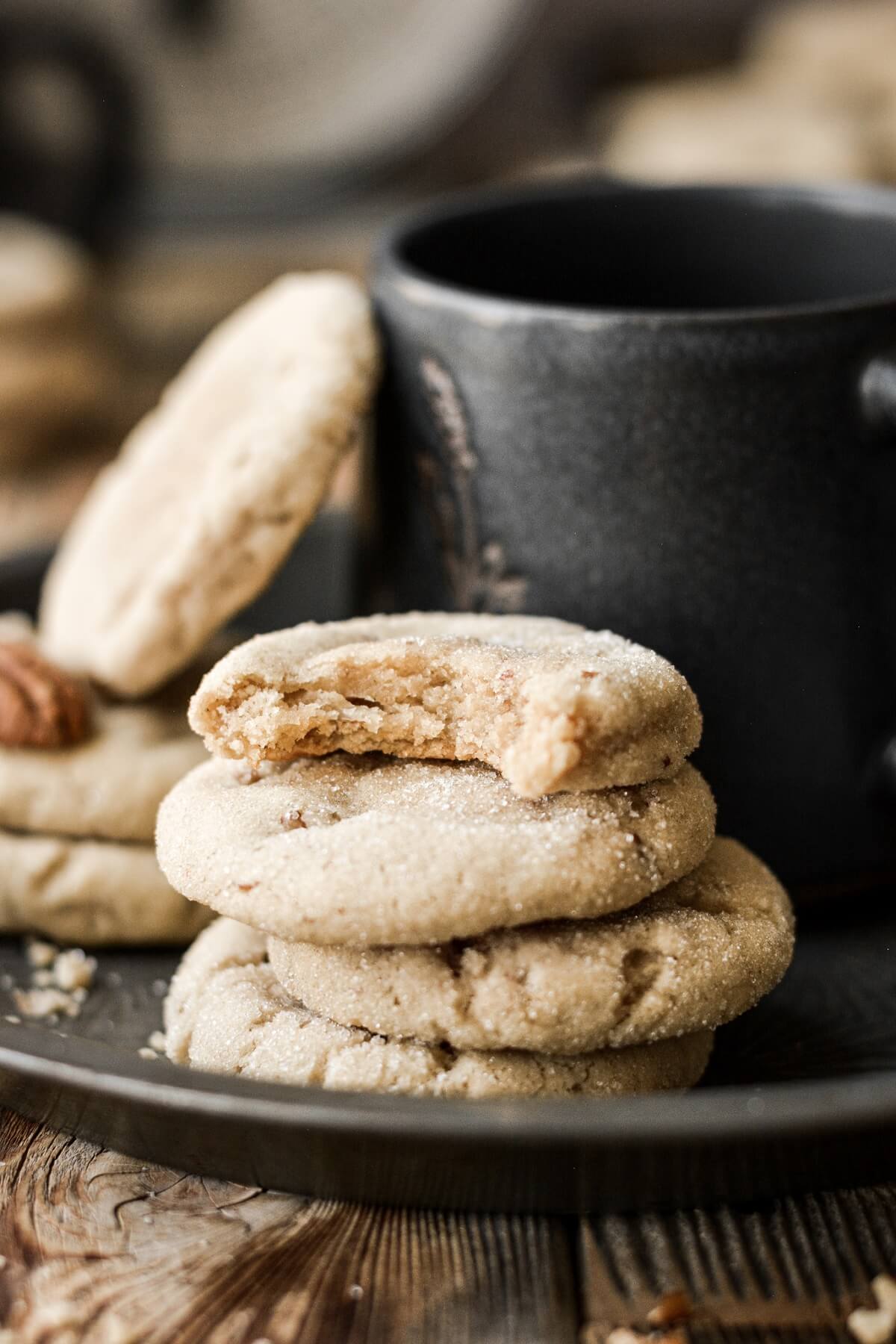 Brown sugar pecan cookies next to a coffee cup.