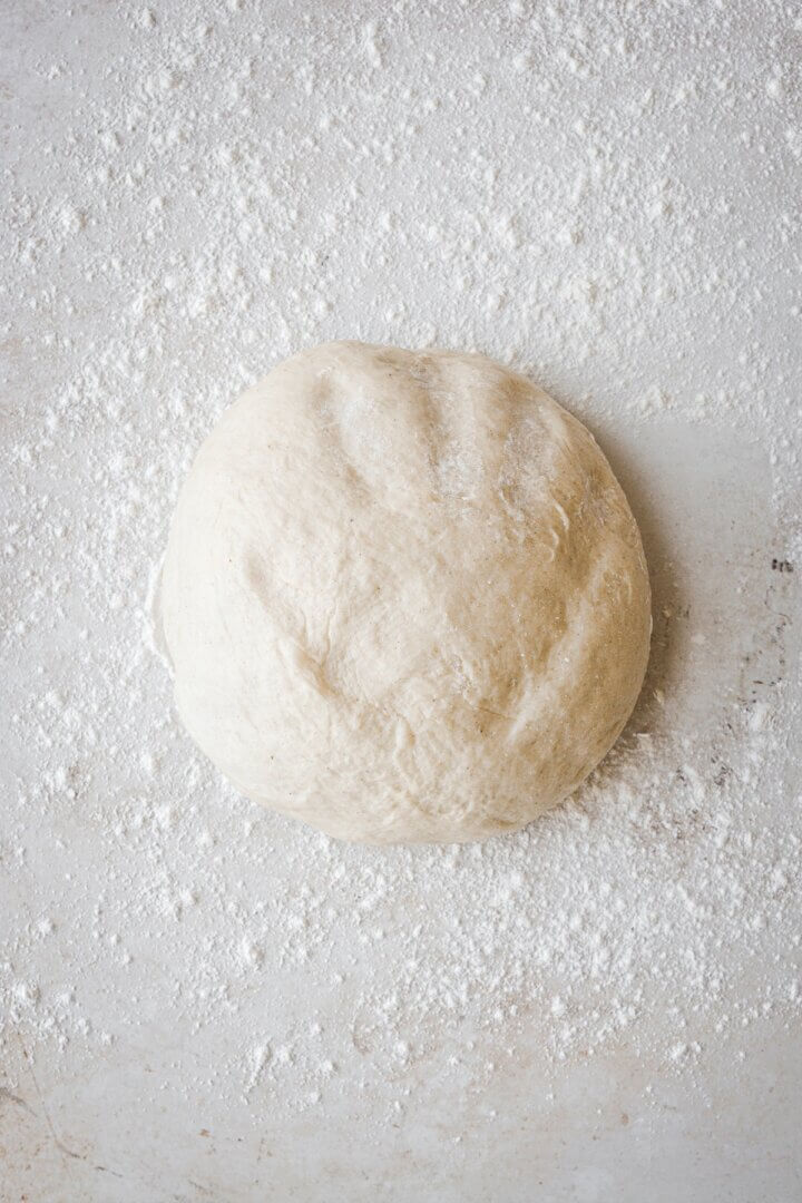 Doughnut dough on a floured surface.
