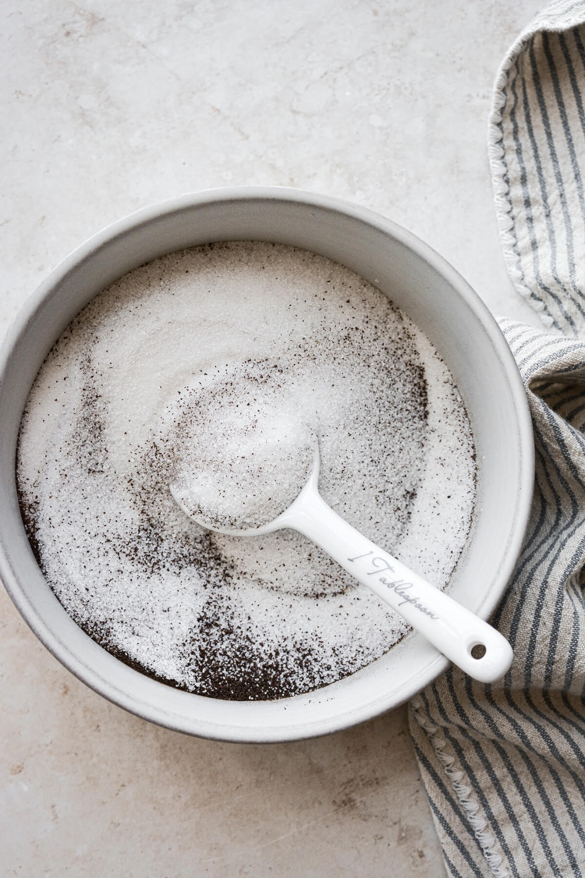 Espresso powder stirred into a bowl of sugar.