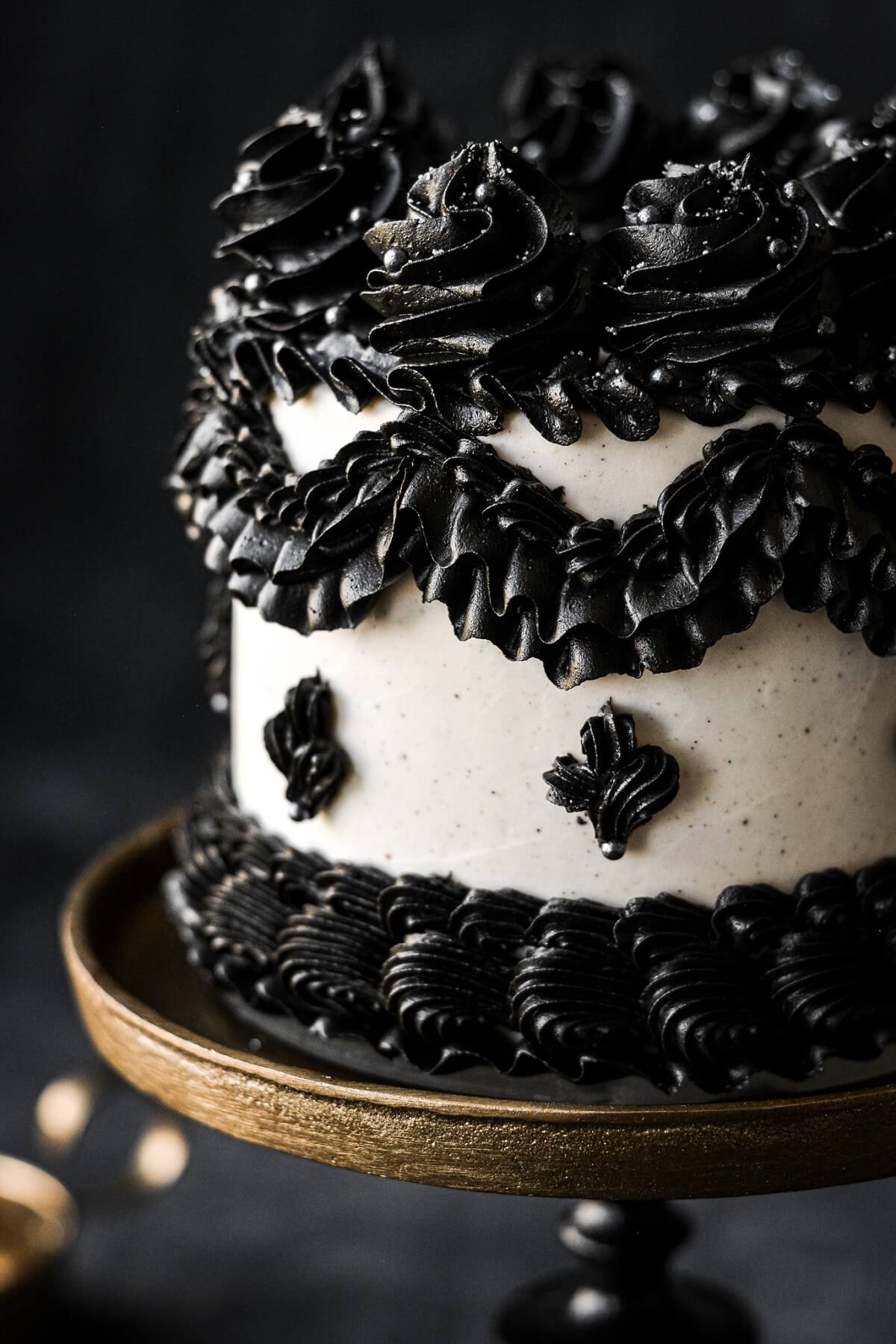 Black buttercream piping on a white cake.