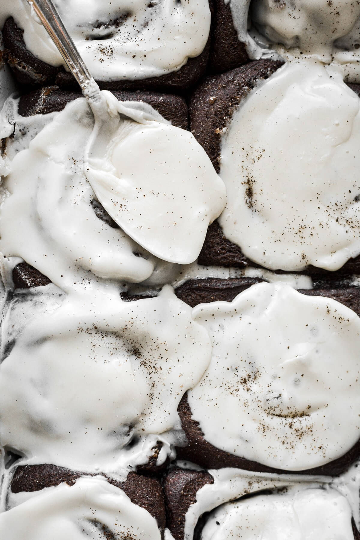 Vanilla icing on chocolate rolls.