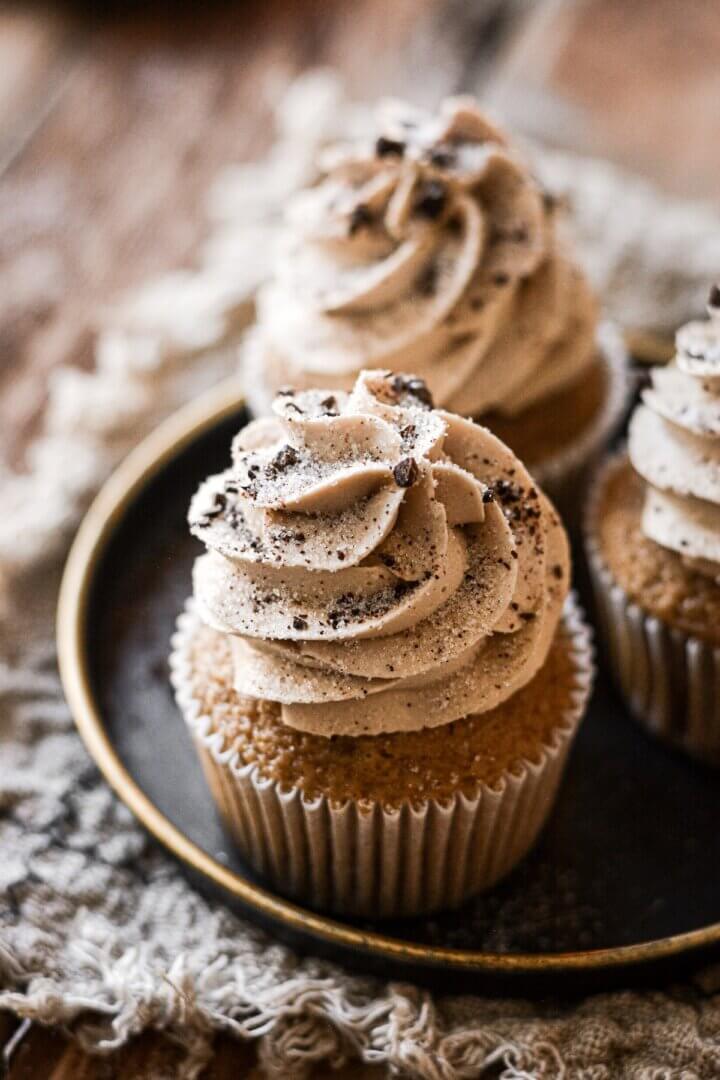 Crushed chocolate covered espresso beans on coffee cupcakes.