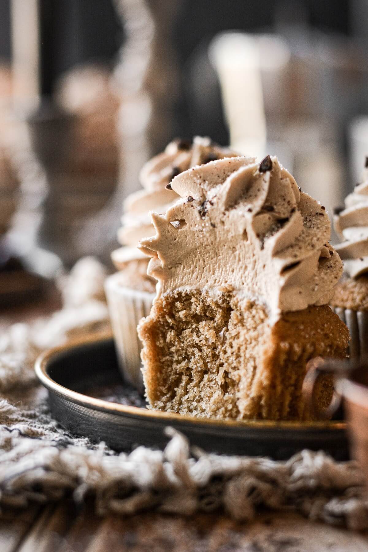 Coffee cupcake with a bite taken.