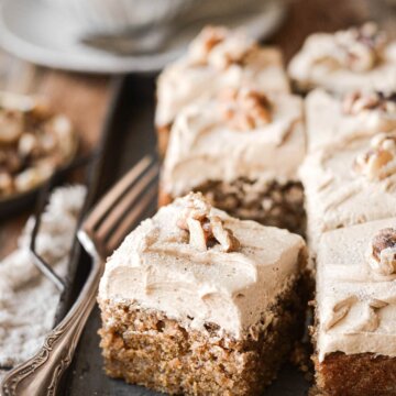 Squares of coffee walnut cake with a cup of coffee.