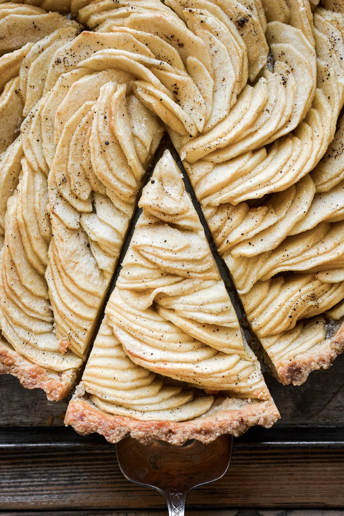 French apple tart with a slice cut.