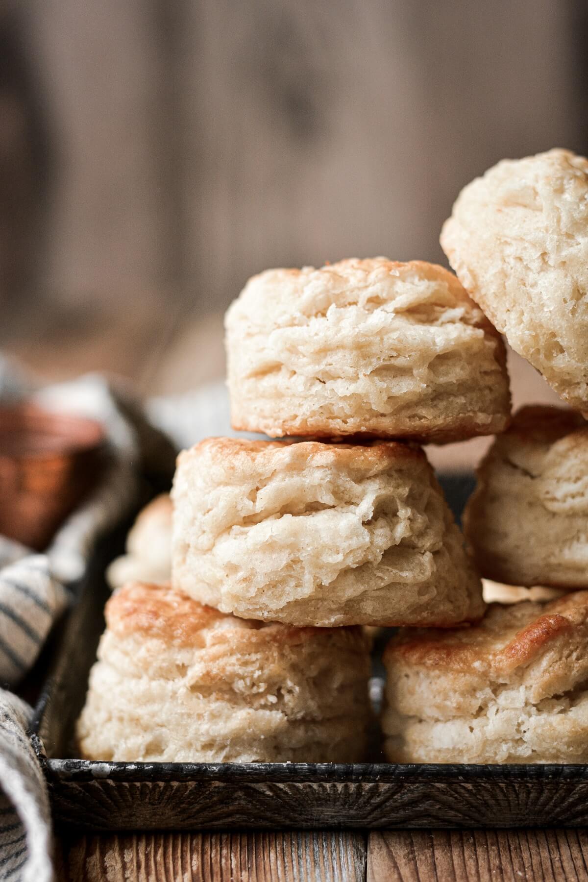 Biscuits stacked on a baking sheet.