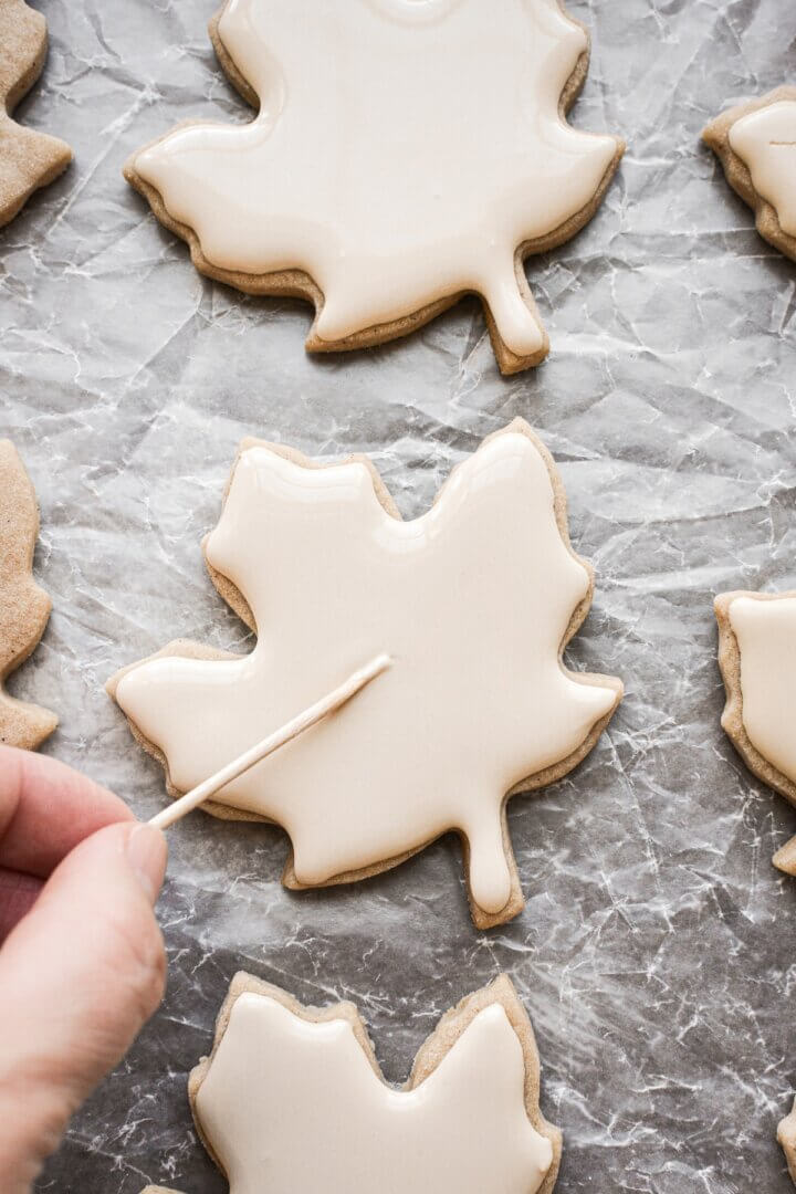 Step 6 for decorating iced maple cut out cookies.