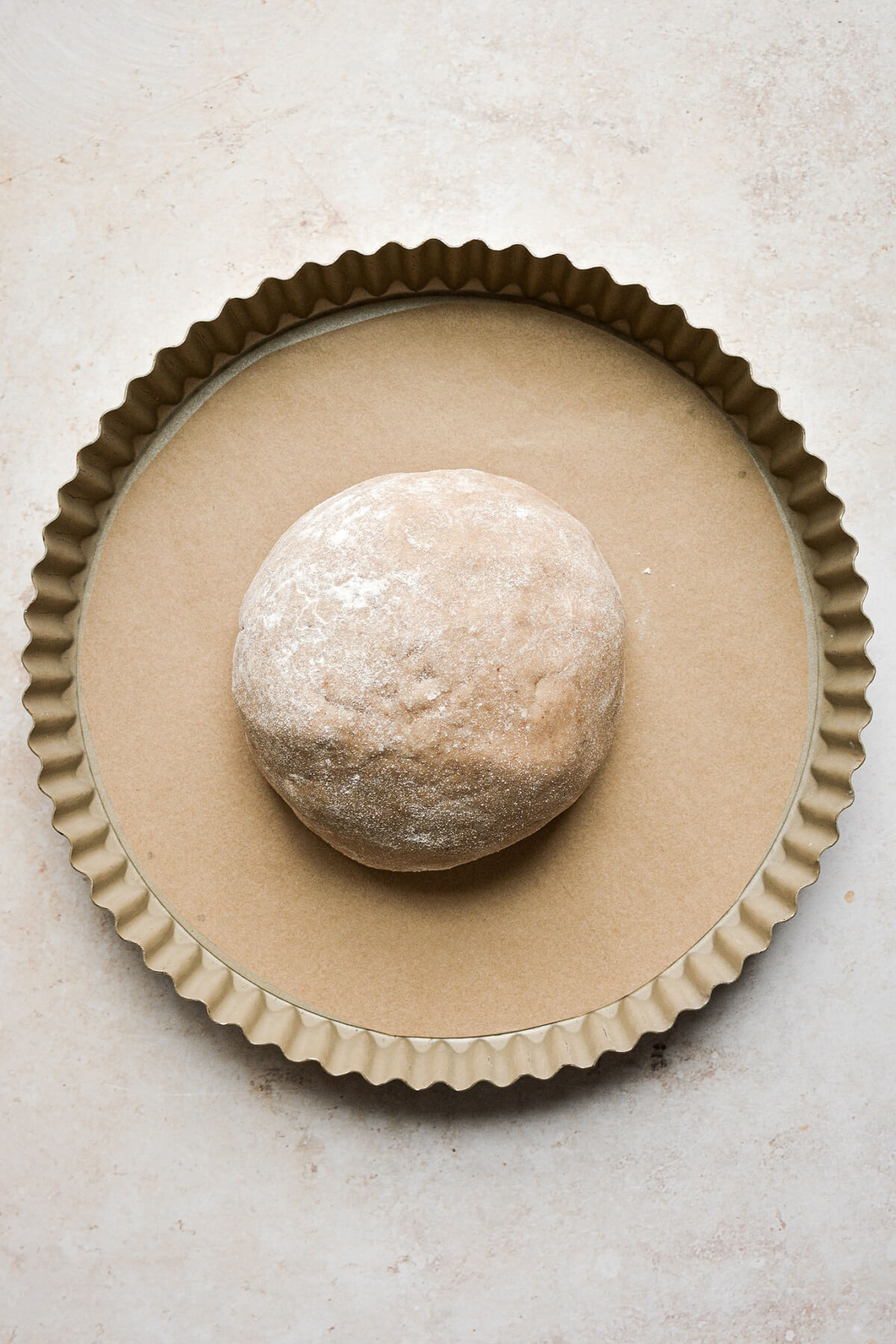 Shortbread dough in a tart pan.