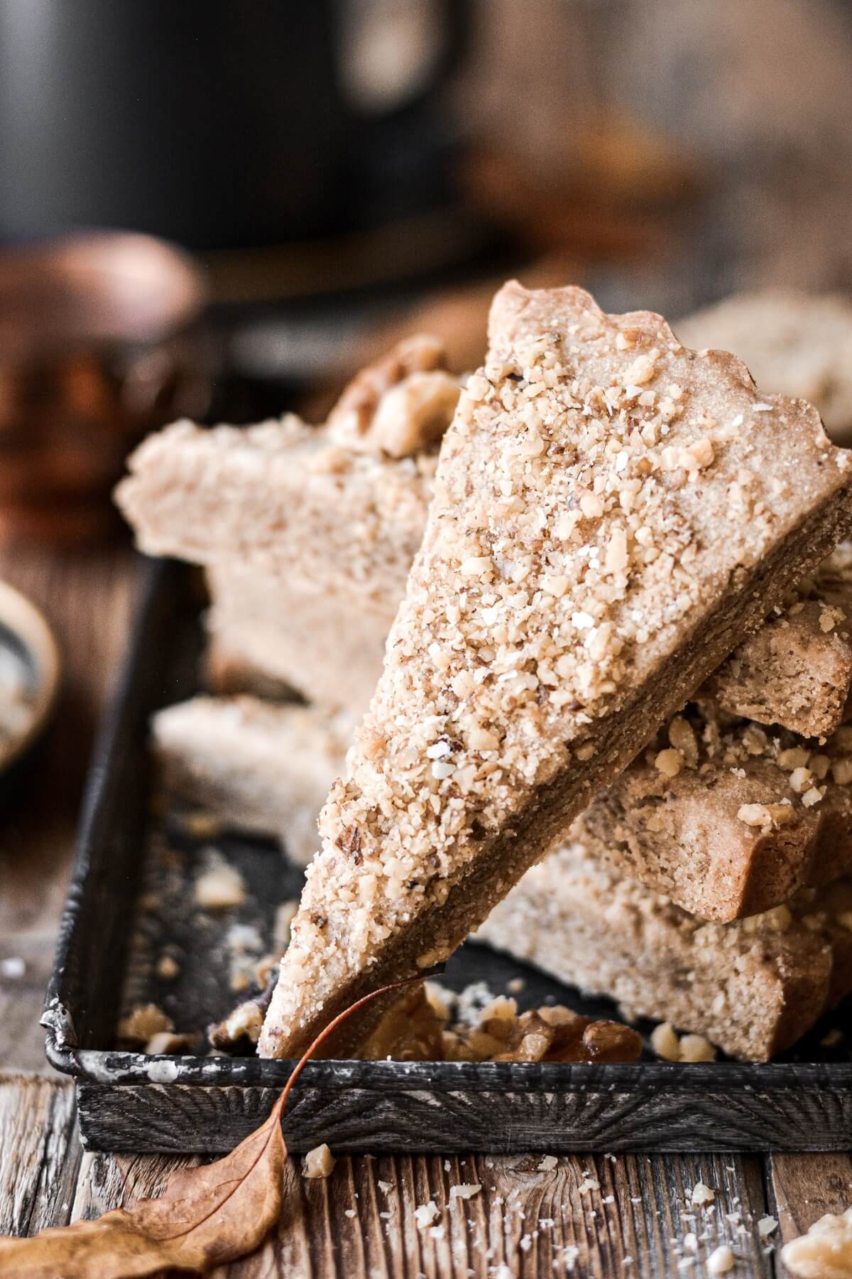 Wedges of maple walnut shortbread sprinkled with chopped walnuts.