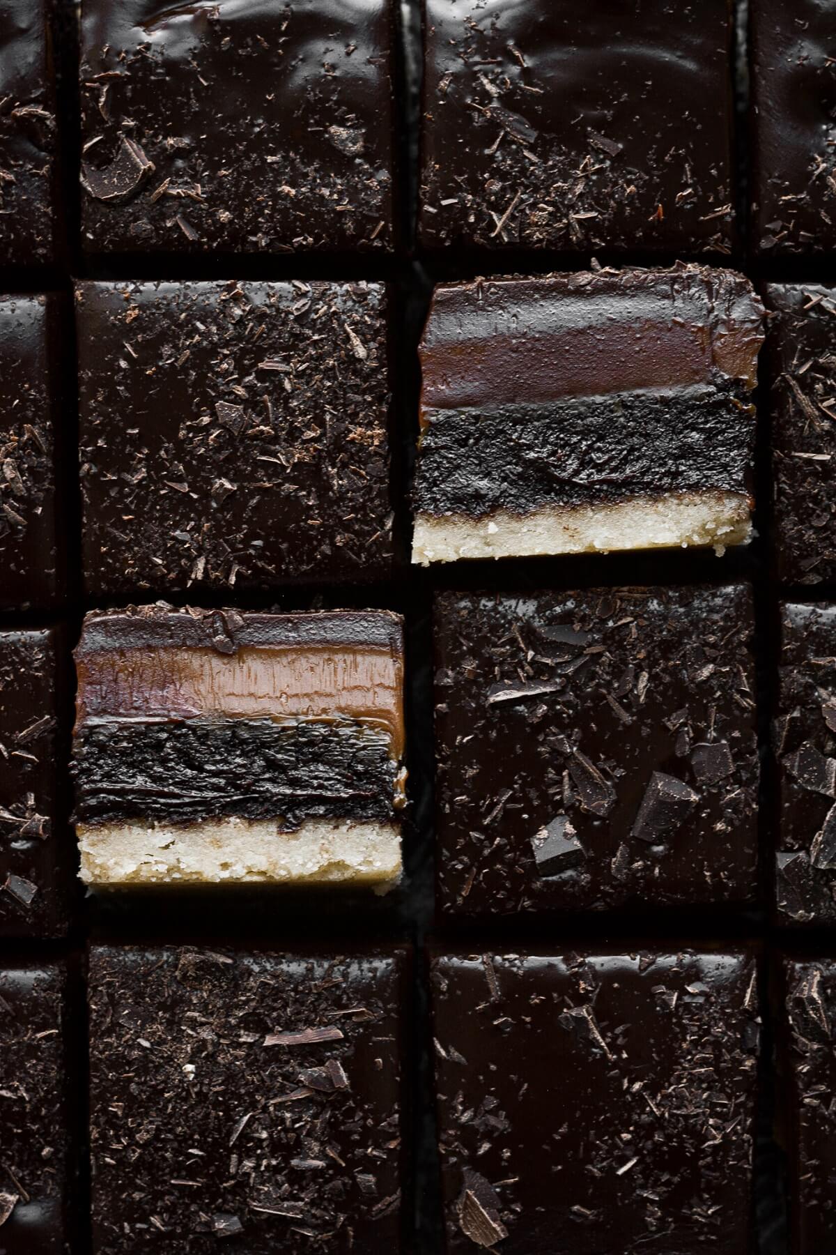 Millionaire shortbread brownie bars with layers of shortbread, brownies, dulce de leche and ganache.