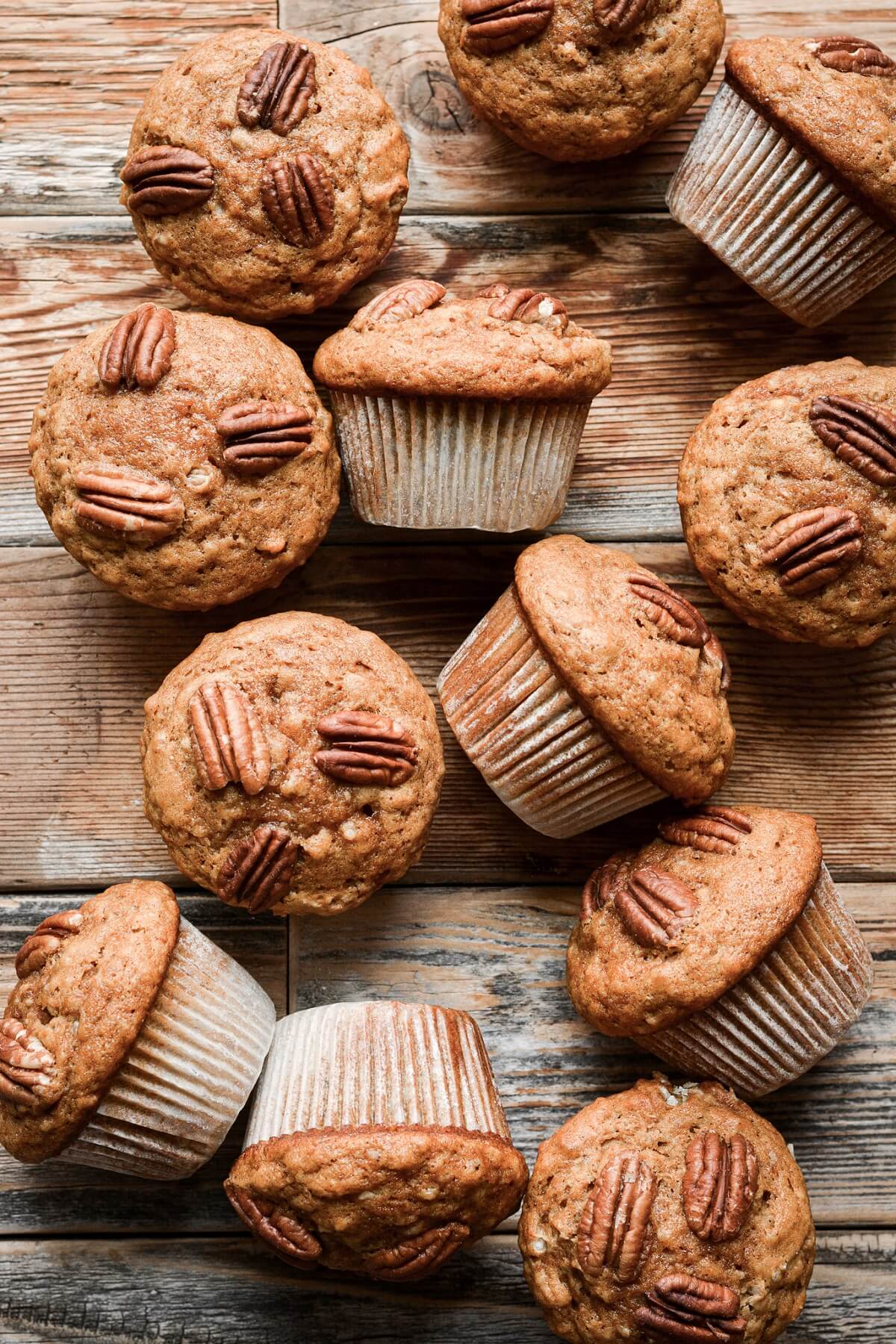 Pumpkin pecan muffins on a wooden table.