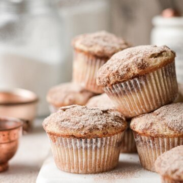 Snickerdoodle muffins on a white marble board.
