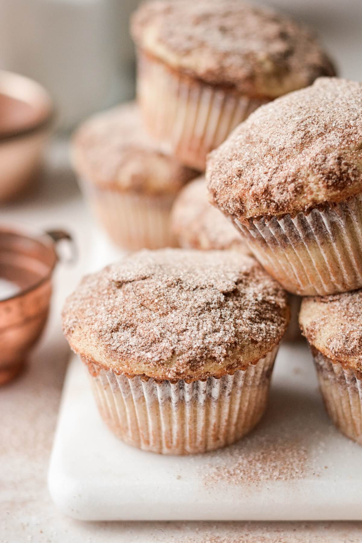 Cinnamon and sugar sprinkled on top of snickerdoodle muffins.