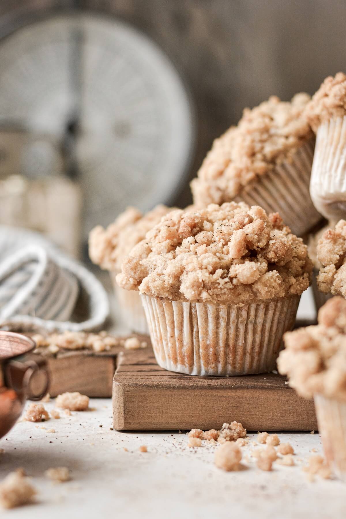Pear crumb muffins on a wooden cutting board.