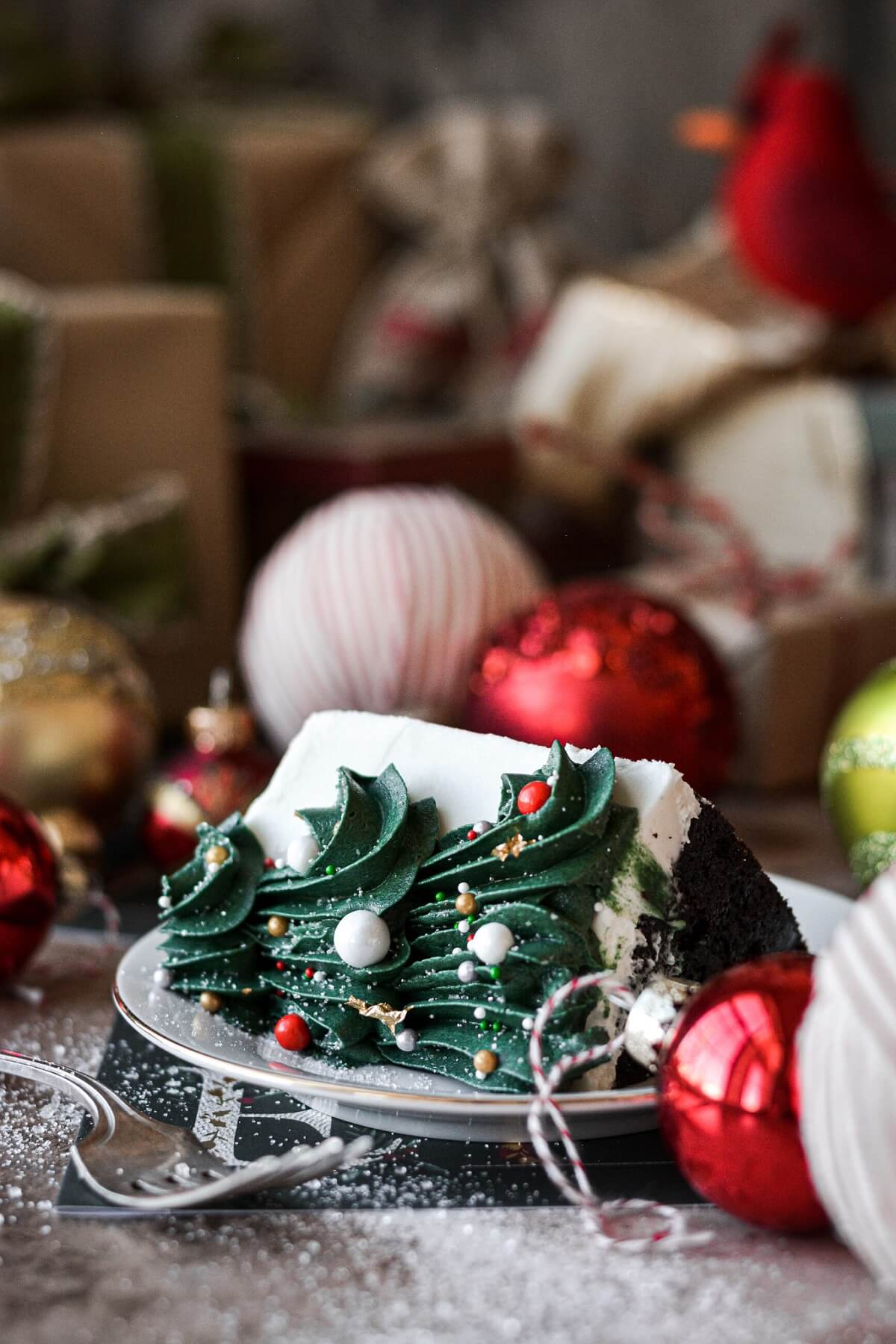Slice of cake with a buttercream Christmas tree.