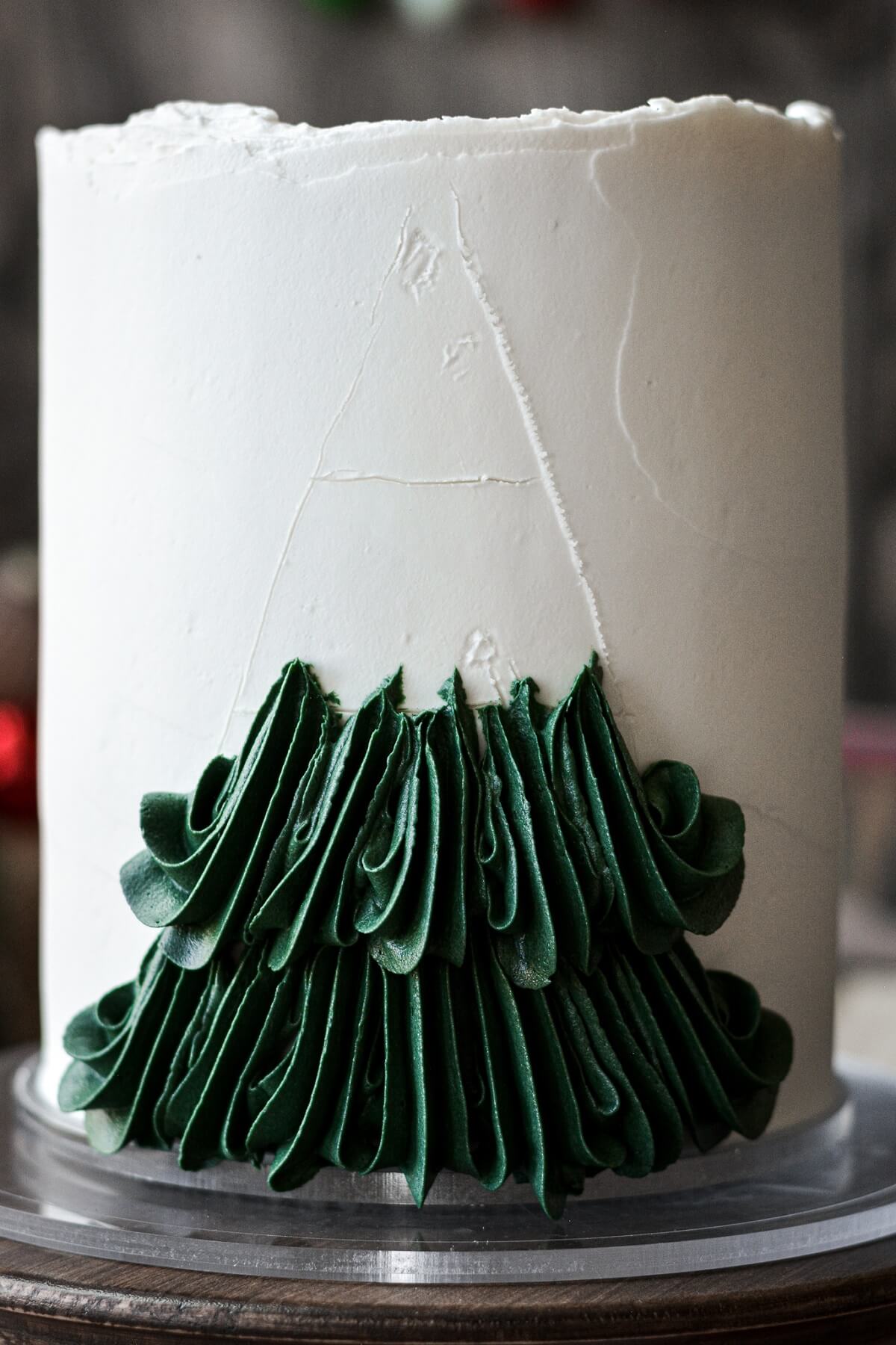 Step 6 for decorating a buttercream Christmas tree cake.