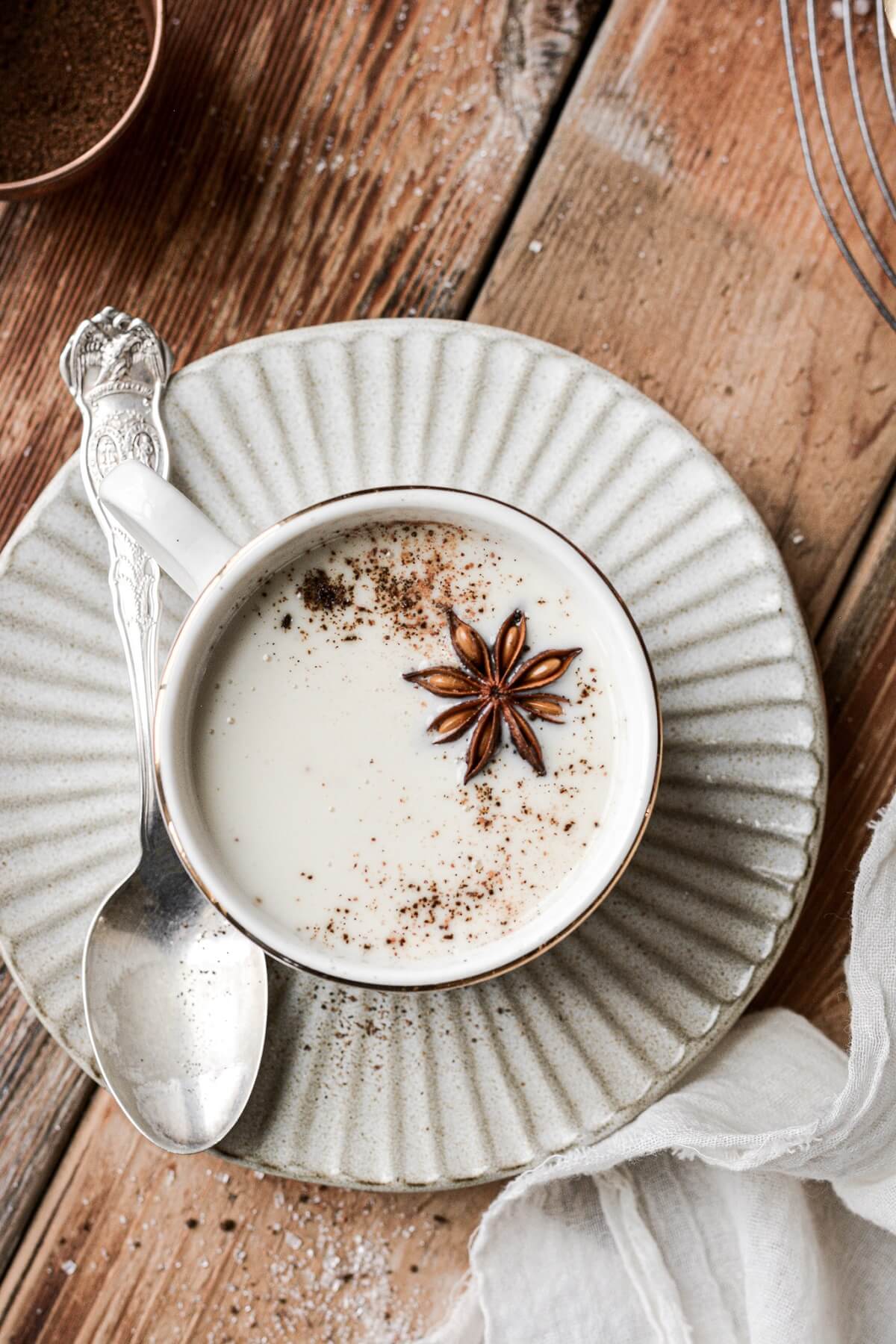 Coconut milk white hot chocolate topped with star anise and nutmeg.