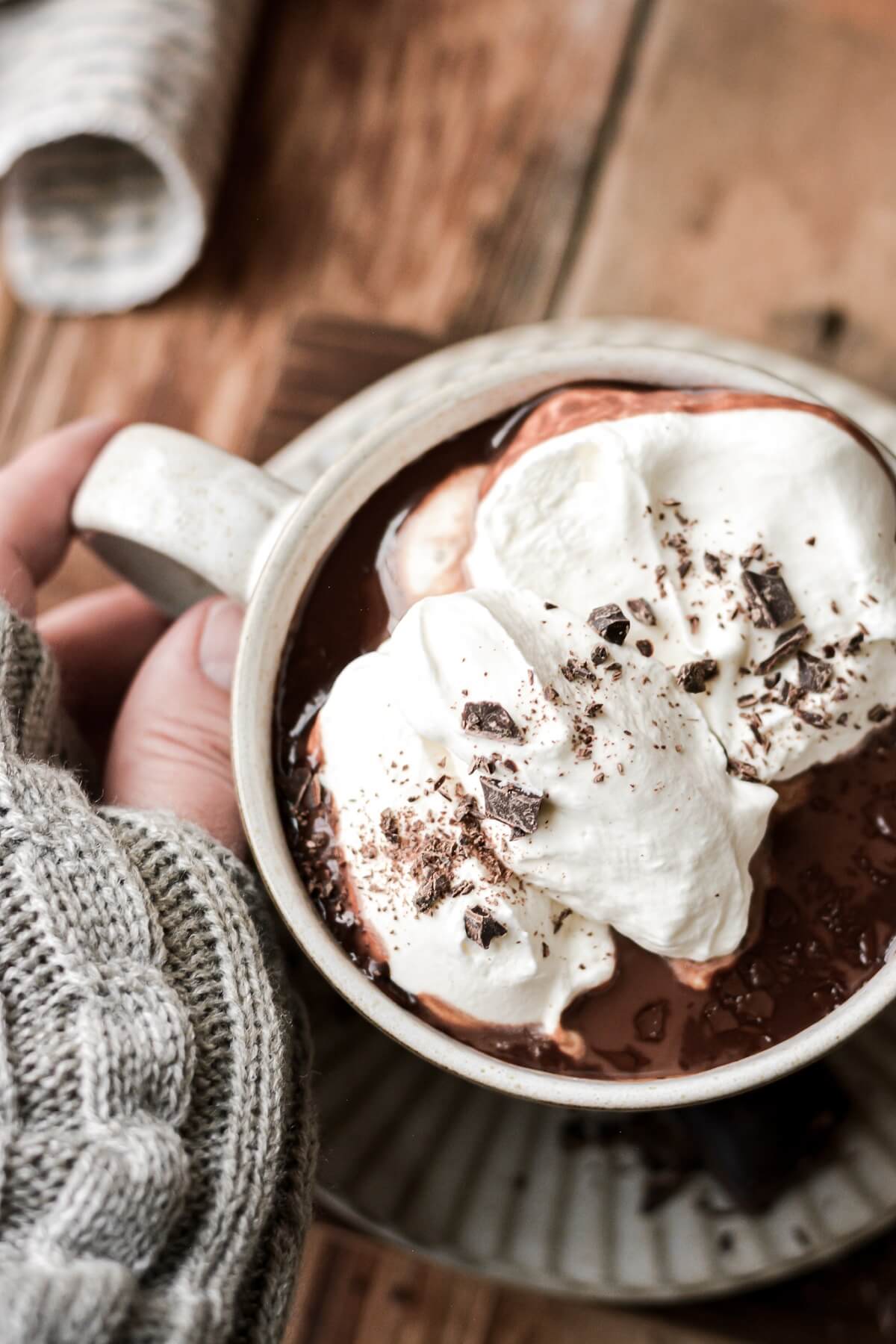 Whipped cream in a cup of hot chocolate.