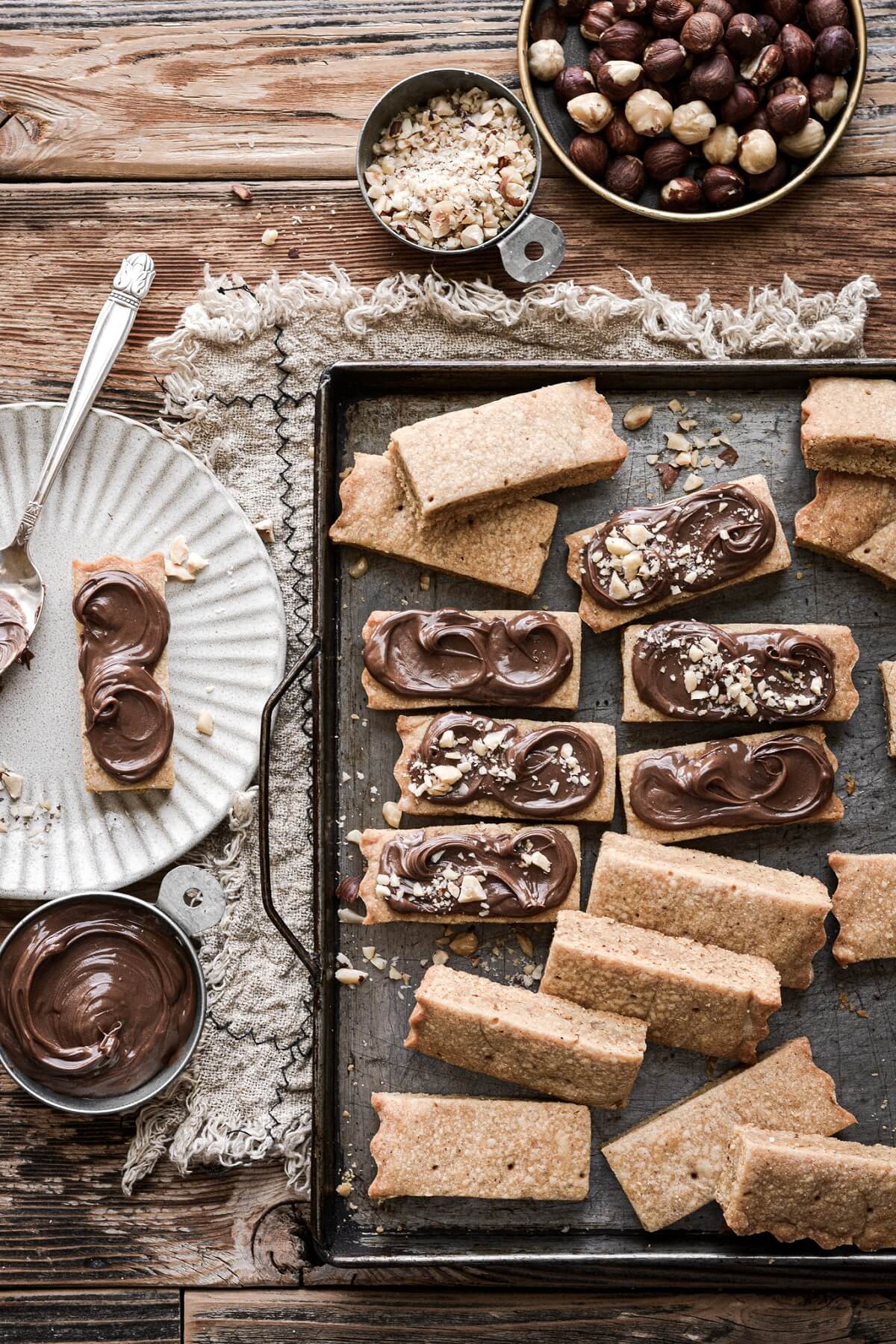 Hazelnut shortbread spread with Nutella and sprinkled with chopped hazelnuts.