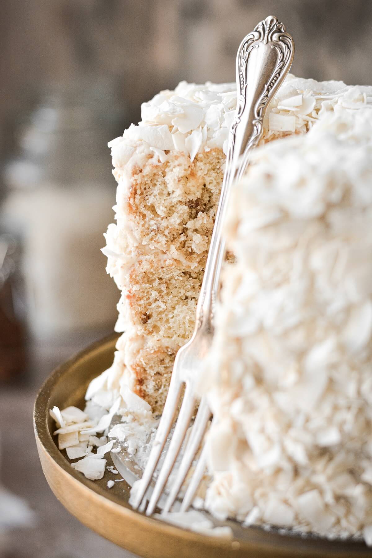 Italian cream cake with a fork resting against it.