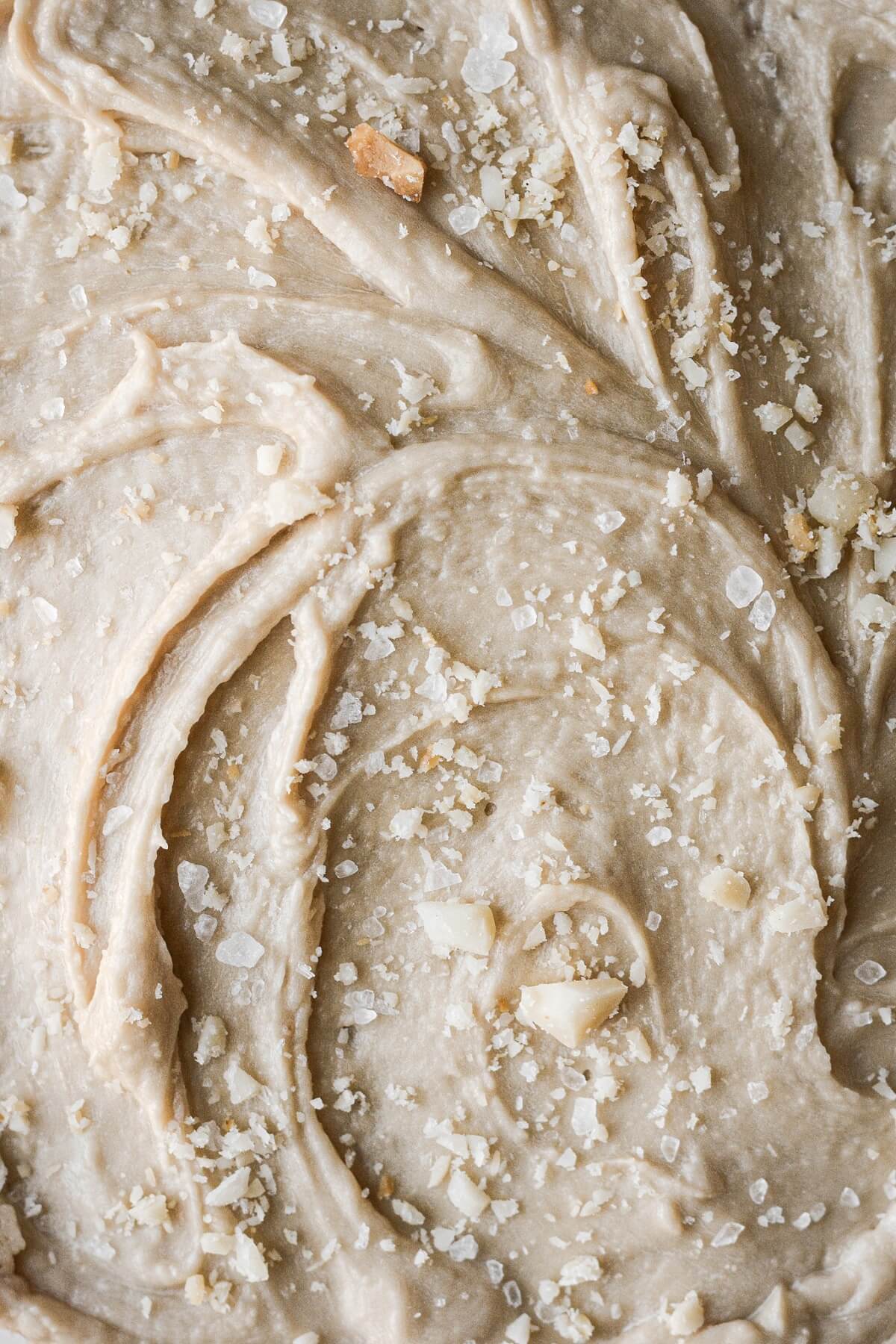 Penuche frosting with chopped macadamia nuts.