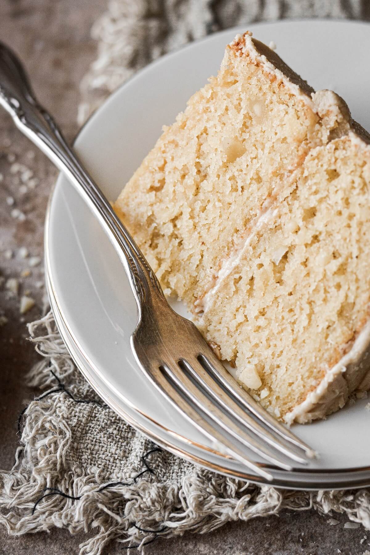 Slice of macadamia nut cake with a vintage fork.