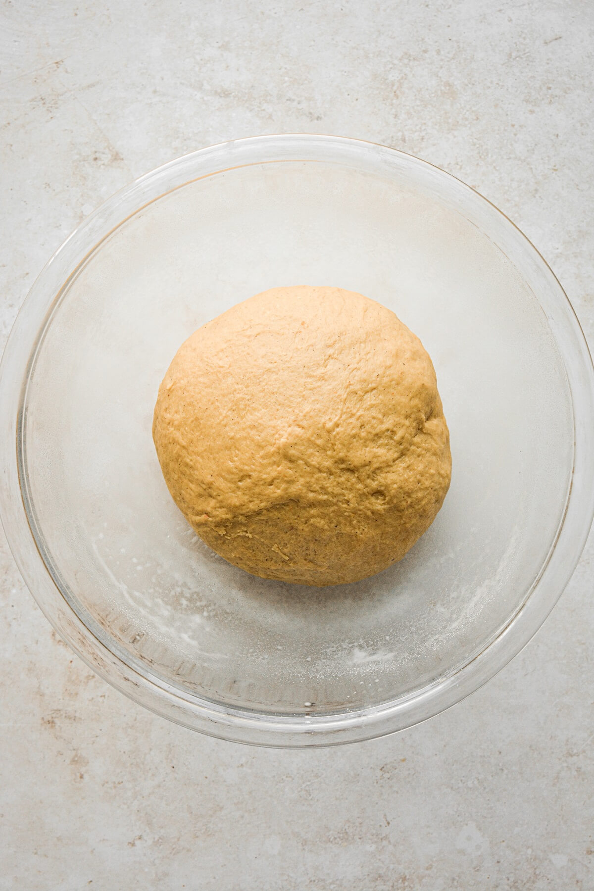 Pumpkin roll dough in a bowl.