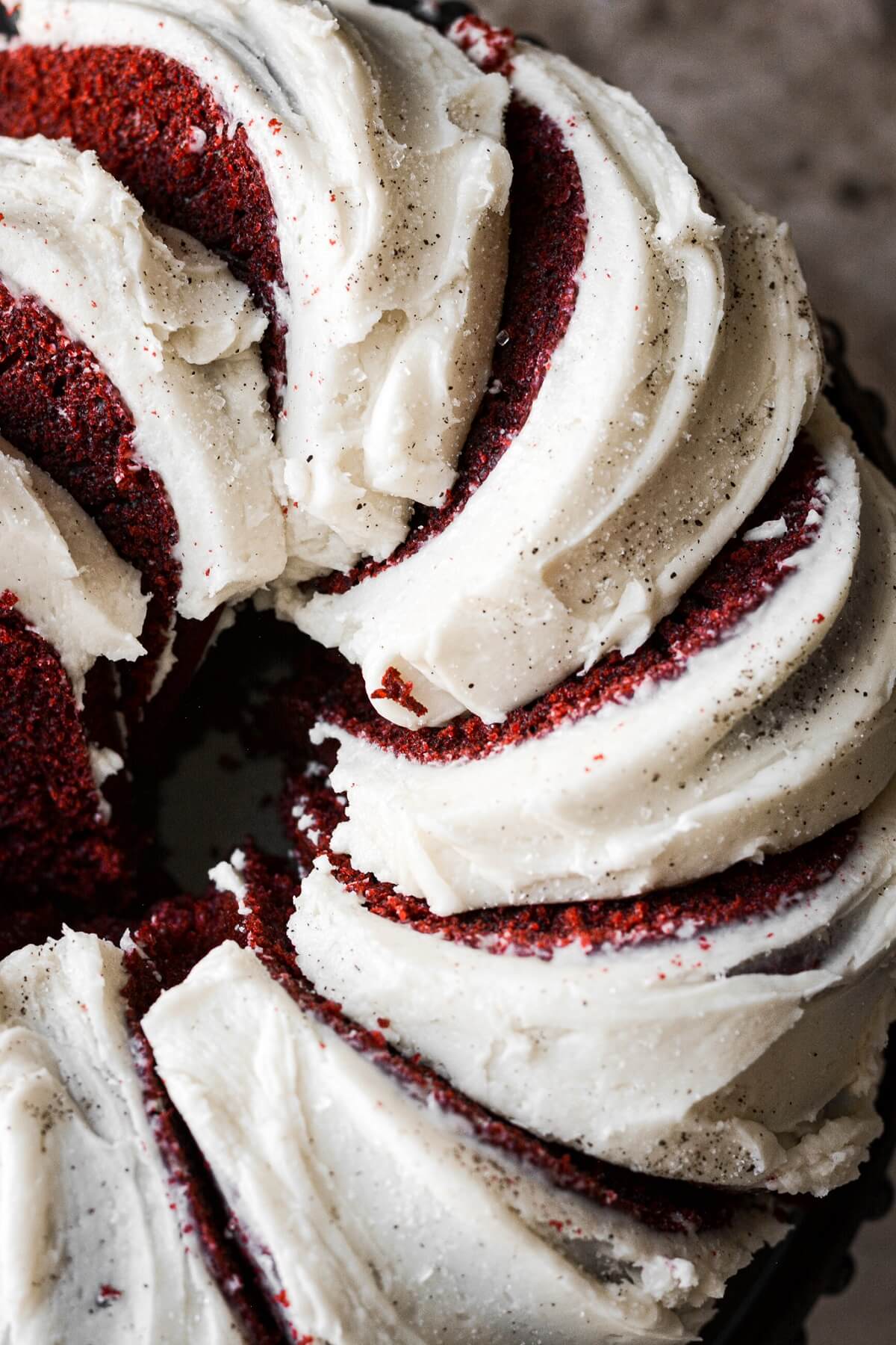 Slices of red velvet bundt cake with cream cheese frosting.