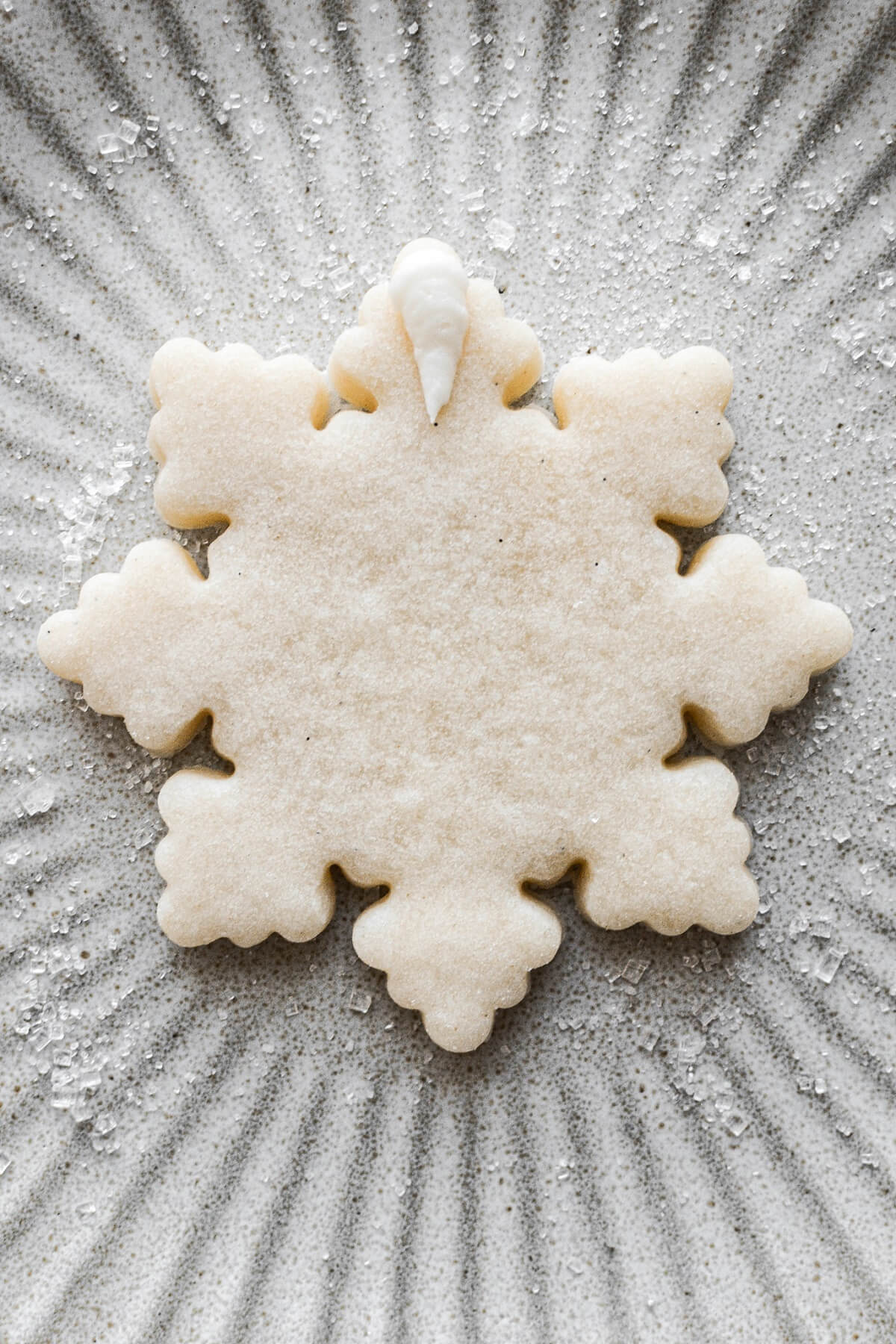 Step 22 for decorating snowflake sugar cookies.