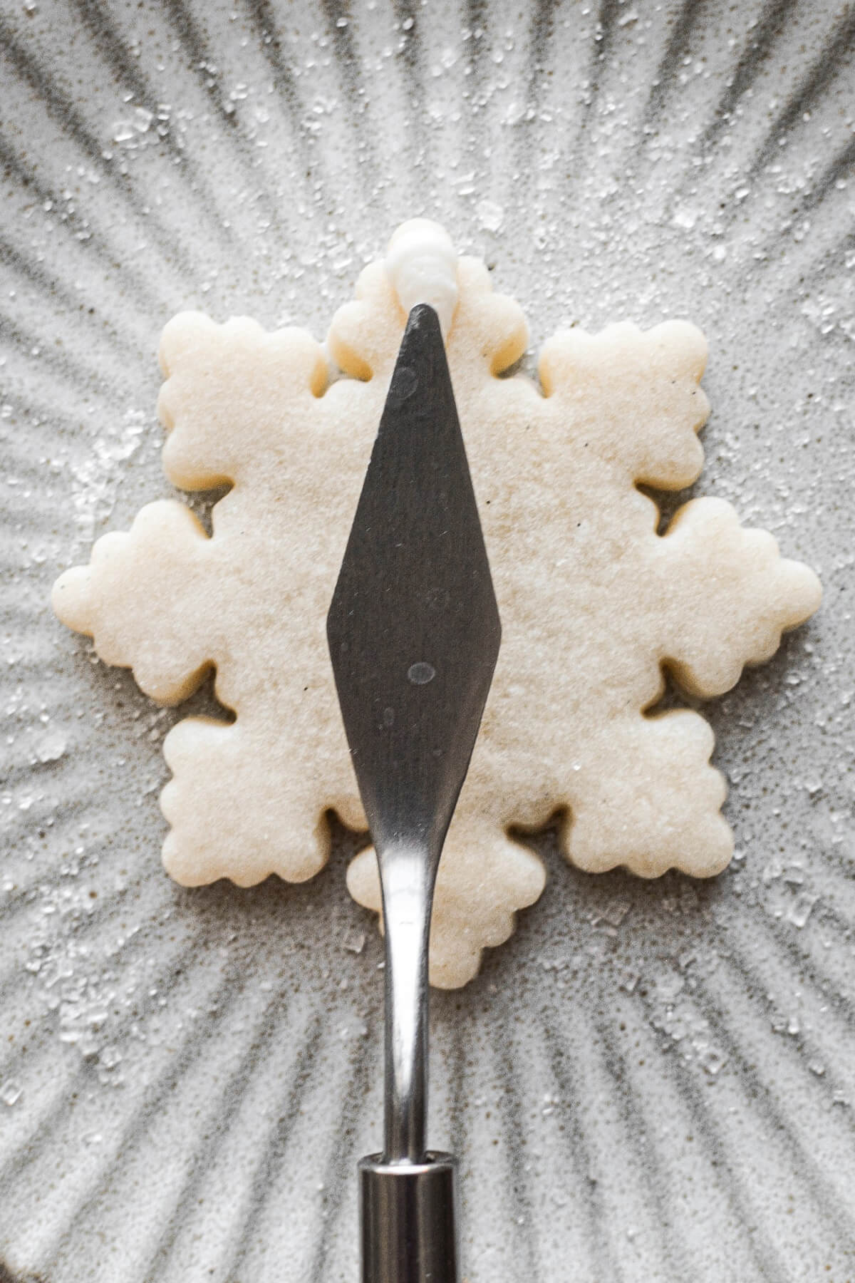 Step 23 for decorating snowflake sugar cookies.