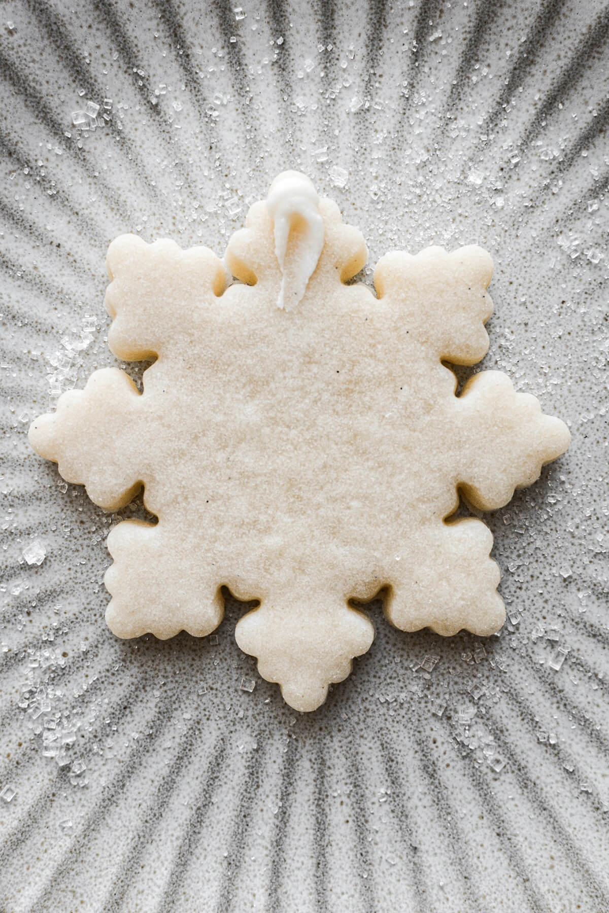 Step 24 for decorating snowflake sugar cookies.