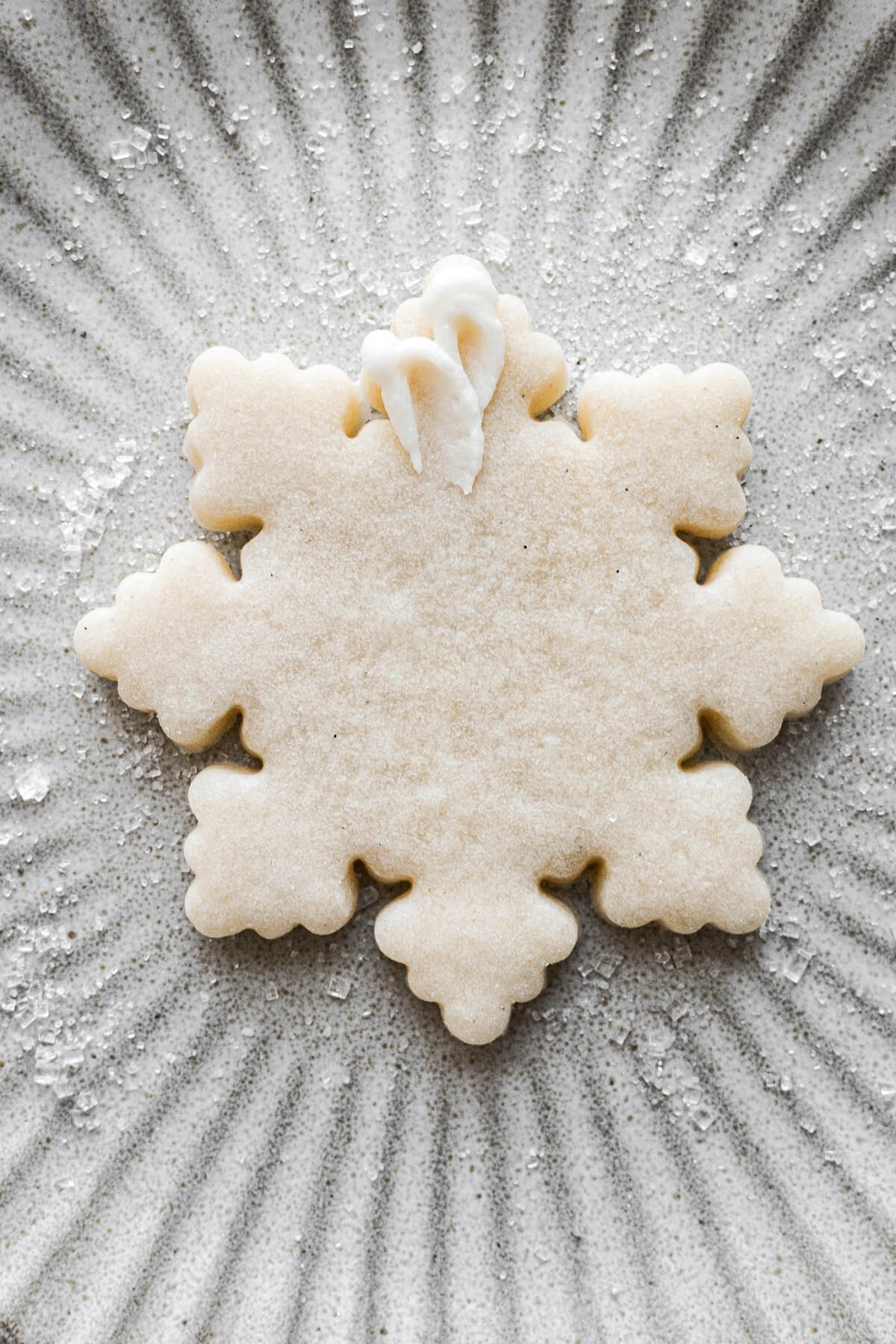 Step 25 for decorating snowflake sugar cookies.
