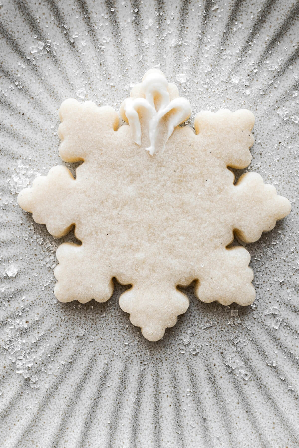 Step 26 for decorating snowflake sugar cookies.