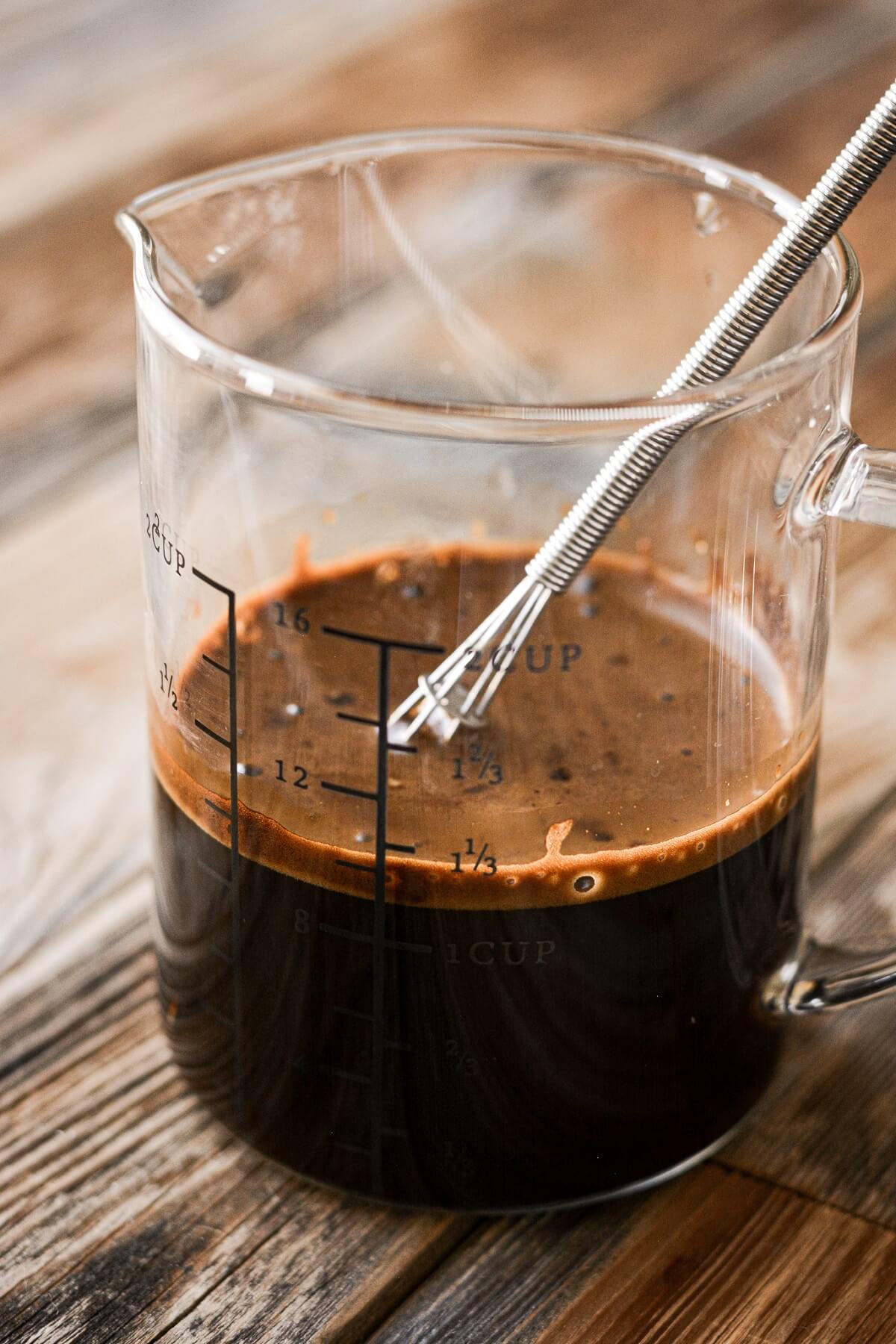 Glass measuring cup of espresso.