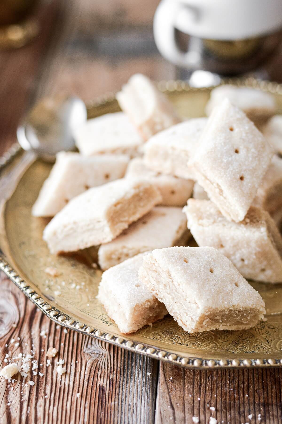 Almond shortbread cookies on a gold plate.