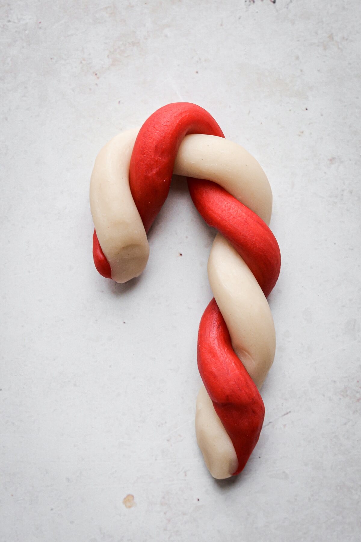 Step 4 for making red and white candy cane cookies.